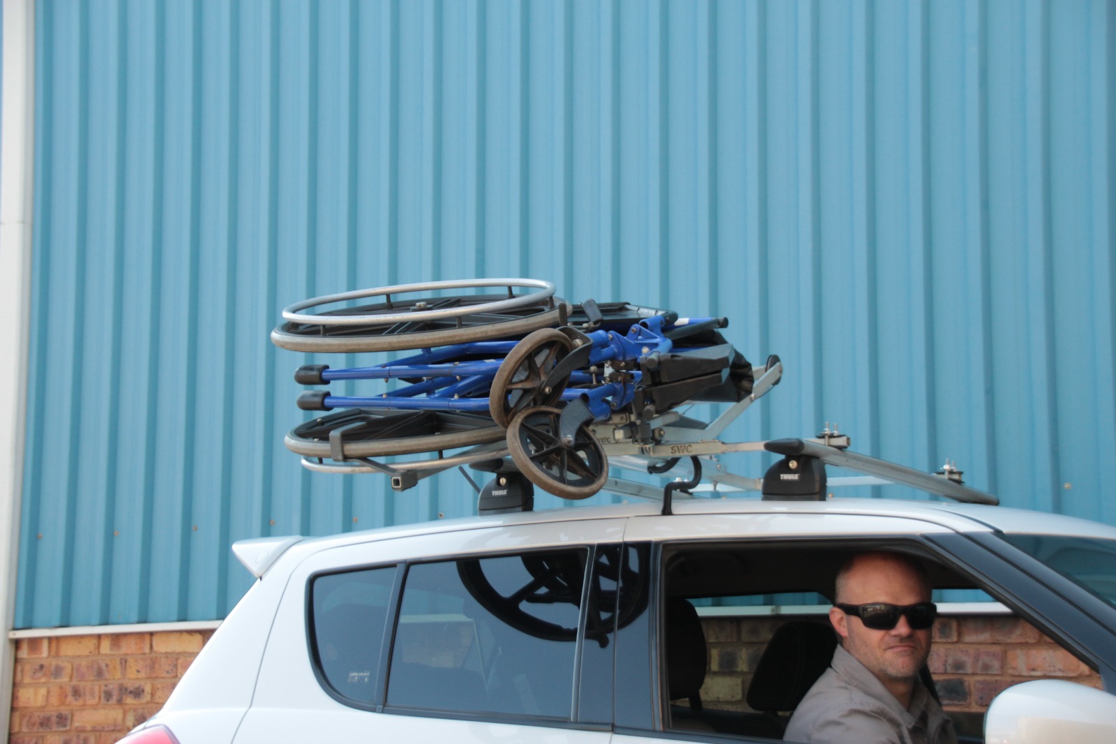 Wheelchair safely and securely loaded onto roof of car