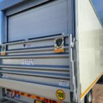 truck roller door in combination with tailgate lift
